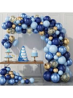 a blue and gold balloon arch for a baby shower