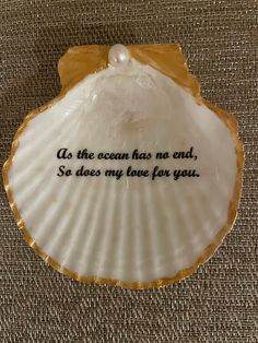 a scallop shell with the words so the ocean has no end, so does my love for you