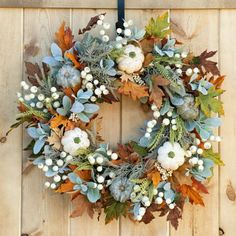 a wreath is hanging on a wooden wall