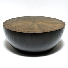 a wooden bowl sitting on top of a white table