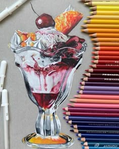 colored pencils and crayons next to a drawing of an ice cream sundae