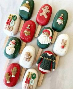 christmas decorations made out of rocks and popsticks