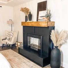 a living room with a fire place and two vases