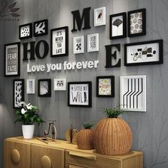 there is a wall with many pictures on it and a vase in front of the dresser