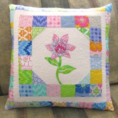 a patchwork pillow with a flower on it