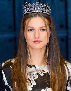 a woman wearing a tiara with long hair