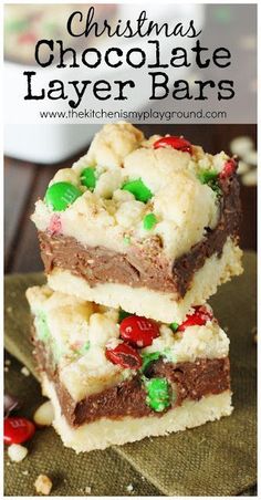 christmas chocolate layer bars stacked on top of each other with candy and marshmallows