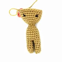 a crocheted teddy bear hanging from a string