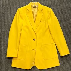 Sunflower Yellow Two Button Blazer. Notch Lapel Patch Pockets. Poly Blend Twill Fabric. 30” Chest. 23” Sleeve. 30” Back Length. Slightly Roomy Fit. Classic Yellow Outerwear With Lapel Collar, Classic Yellow Blazer For Business, Elegant Yellow Blazer With Pockets, Yellow Notch Lapel Outerwear For Office, Yellow Single Breasted Blazer With Lapel Collar, Classic Single-breasted Yellow Blazer, Yellow Single-breasted Blazer With Lapel Collar, Yellow Single-breasted Notch Lapel Blazer, Classic Fitted Yellow Outerwear