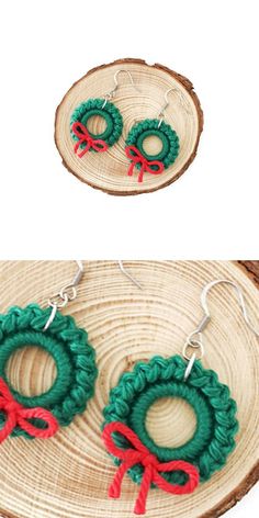 the earrings are made from yarn and have red bows on each earring, which is attached to a piece of wood