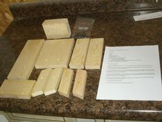 several pieces of wood sitting on top of a counter next to a piece of paper