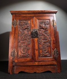 an old wooden cabinet with carvings on the doors