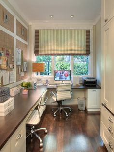 an office with wood floors and white cabinets