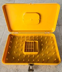 an open yellow suitcase sitting on the ground