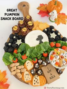 a wooden platter filled with lots of different types of snacks and candies on it