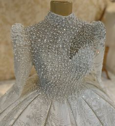 a white dress with silver beads on it