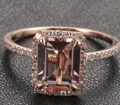 an engagement ring with a large brown diamond in the center and pave diamonds around it