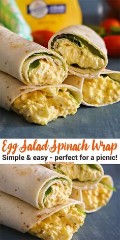 an egg salad spinach wrap is cut in half and stacked on top of each other