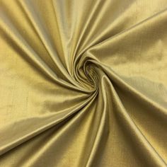 a close up shot of a gold colored fabric that is very soft and shiny,