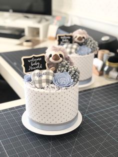 two cakes decorated with teddy bears sitting on top of a table