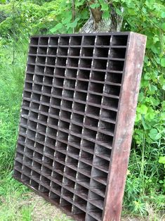 an old wooden crate sitting in the grass