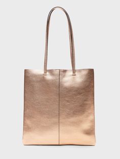 The perfect day tote, designed with a low-profile shape so it packs flat, made in sturdy, luxe leather.  Magnetic snap closure.  2 interior slip pockets.  Faille lining.  Height: 14" (35. 5cm) Width: 13. 4" (34cm) Handle drop: 12" (30cm) Gold Rectangular Bags For Work, Rectangular Gold Bags For Work, Gold Rectangular Workwear Bags, Gold Double Handle Work Bags, Gold Double Handle Shoulder Bag For Work, Versatile Shopping Bag With Leather Lining, Modern Gold Bag For Work, Gold Leather Bag For Work, Gold Leather Bag For Workwear