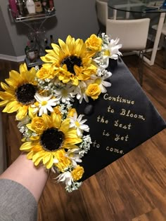 a graduation cap with sunflowers and daisies on it that says, continue to bloom the best is yet to come