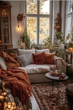 a living room filled with lots of furniture and plants on the windows sills