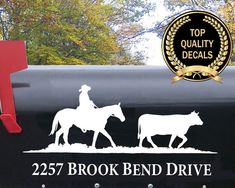 a mailbox with a horse and rider decal next to it that reads, 2237 brook bend drive