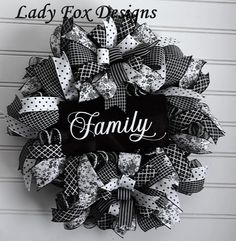 a black and white mesh wreath with the words lady fox designs on it