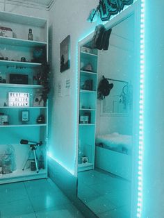 the room is lit up with blue lights and there are bookshelves in it