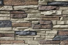 a stone wall with several different colors and shapes