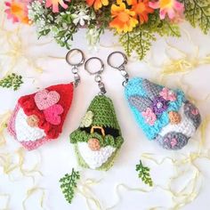 two crochet keychains are sitting next to each other