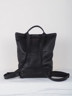 "Black Leather backpack purse women, laptop backpack, zipper backpack, backpack bag, handmade backpack, black leather backpack, minimal bag Handmade HIBRID black Leather Backpack is characterized by its hand crafted and material quality and locally sourced. Large capacity backpack designed with cowleather. Details: Back metalic Zipper clousure. Zipper pocket on the back. Inside leather pocket smartphone size Leather handel and black cotton straps + black leather adjustable. * Color: base black c Minimalist Leather Backpack For Daily Use, Minimalist Everyday Backpack, Minimalist Black Leather Backpack For Travel, Minimalist Backpack With Adjustable Strap, Minimalist Backpack For Daily Use, Minimalist Black Leather Backpack For Daily Use, Minimalist Black Leather Backpack, Minimalist Black Travel Backpack, Black Minimalist Backpack For Everyday