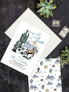 two wedding cards on top of each other next to some succulents and cacti