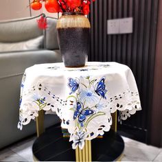 a vase filled with red and blue flowers on top of a table next to a couch