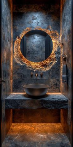 a bathroom with stone walls and a round mirror on the wall, along with a sink