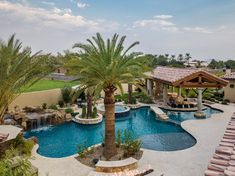 an outdoor swimming pool surrounded by palm trees and water features a gazebo with seating