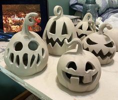 some white pumpkins sitting on top of a table