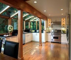 an open kitchen and dining room with wood flooring