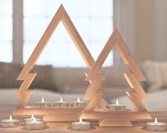 candles are arranged in triangle shapes on a table