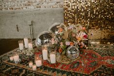 a table topped with lots of candles and disco balls