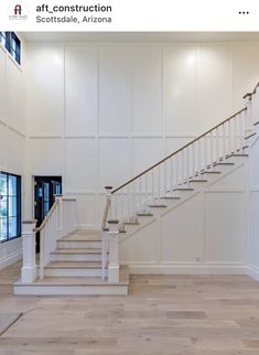 an empty room with white walls and stairs