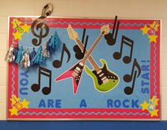 a bulletin board with musical notes and guitars