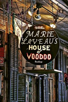 a sign hanging from the side of a building that says marquee aveaus house voodoo