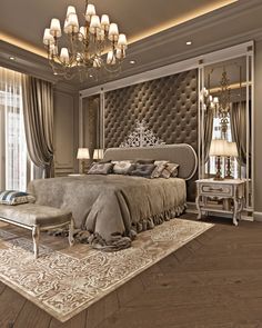 a large bed sitting in the middle of a bedroom next to a chandelier