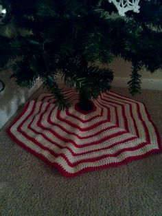 a crocheted rug under a christmas tree