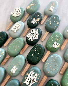 green and white cake pops with gold sprinkles on them that say happy birthday