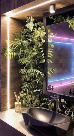 a bathroom with plants on the wall and a sink in front of a large mirror