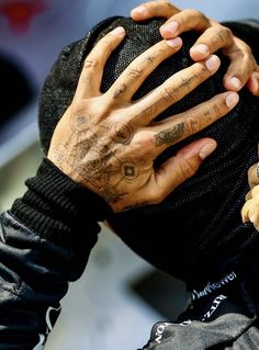 a man with tattoos covering his face and hands